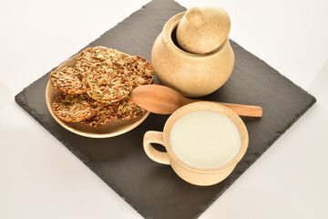 A few delicious walnut cookies, close-up, on a slate board.