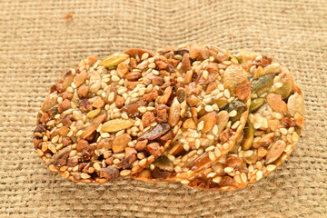 A few delicious walnut cookies, close-up, on jute fabric.