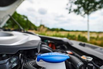 A look into the engine compartment of a plug-in hybrid car with various components.