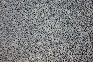 Small road stone background, dark wet gravel pebble stone texture seamless texture. Top view.