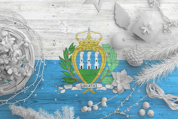 San Marino flag on wooden table with snow objects. Christmas and new year background, celebration...