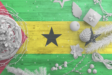 Sao Tome And Principe flag on wooden table with snow objects. Christmas and new year background,...