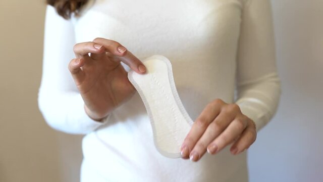 Young woman holding menstrual pad