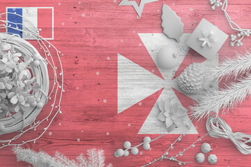 Wallis And Futuna flag on wooden table with snow objects. Christmas and new year background, celebration national concept with white decor.