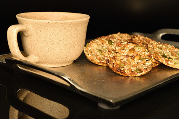 Several fresh fragrant tasty nutty cookies on a black background.