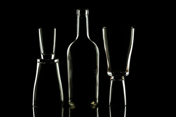 piles stacked on top of each other and between them an empty bottle