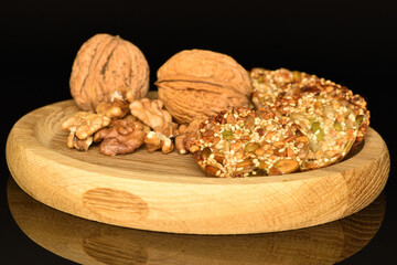 Several fresh fragrant tasty nutty cookies on a black background.