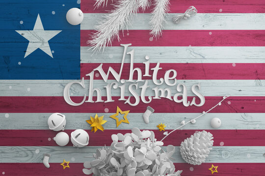 Liberia flag on wooden table with White Christmas text. Christmas and new year background, celebration national concept with white decor.