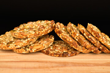 Several fresh fragrant tasty nutty cookies on a black background.