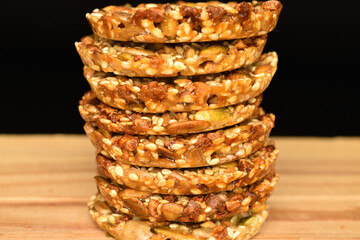 Several fresh fragrant tasty nutty cookies on a black background.