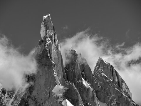 Grayscale shot of the Cerro Torre sharp mountain tops covered in snow on Argentina