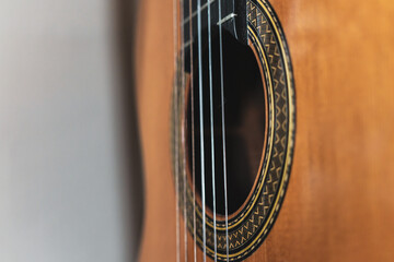 Strings, rosette and sound hole of a classical guitar