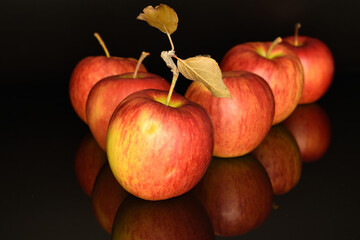 Ripe red apples, close-up, on a black background.