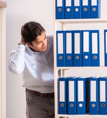 Young male employee working in the office