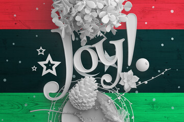 Libya flag on wooden table with Joy text. Christmas and new year background, celebration national...