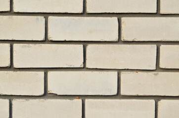 White brick wall. Texture. Background. The seams between the bricks are made of cement. It's a good one. Building. Copy space for text.