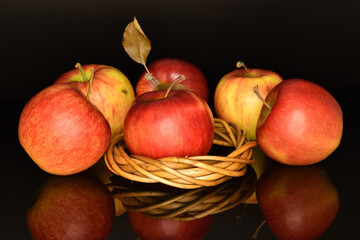 Ripe red apples, close-up, on a black background.