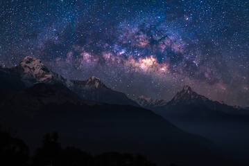 Nature landscape view of Himalayan mountain range with universe space of milky way galaxy and stars on night sky