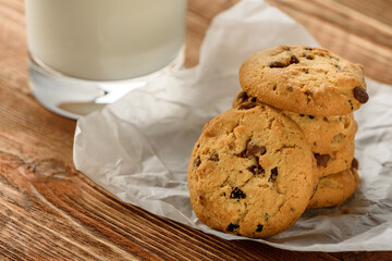 Tasty cookies and glass of milk on  wooden background