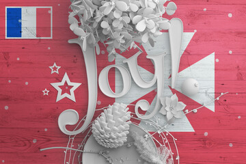 Wallis And Futuna flag on wooden table with Joy text. Christmas and new year background,...