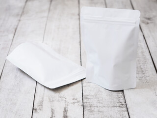 Empty white zip package for food on vintage wooden table.