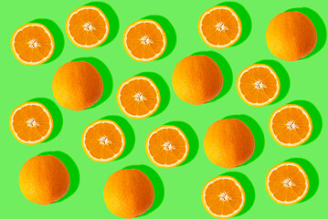 sorted cut orange on green background. Image of fresh oranges for the summer.
refreshing background.