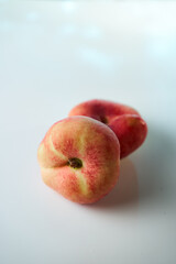 red ripe peaches on a white background. Close-up.