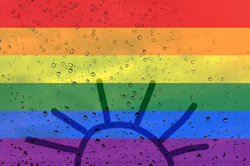 Rainbow flag on background with raindrops. Drawing the sun inside out.n.