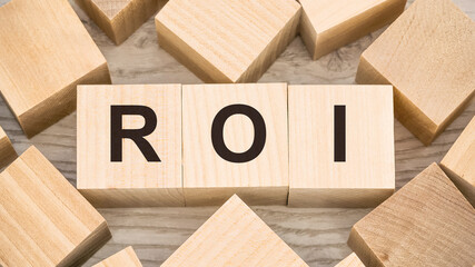 black letters roi on small wooden blocks and empty details
