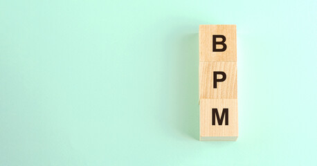 black letters bpm on wooden blocks and space for design