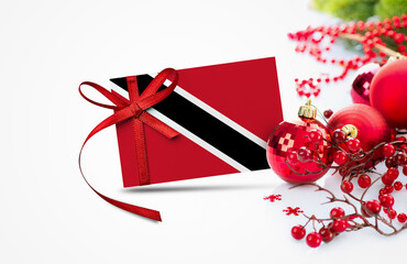 Trinidad And Tobago flag on new year invitation card with red christmas ornaments concept. National...