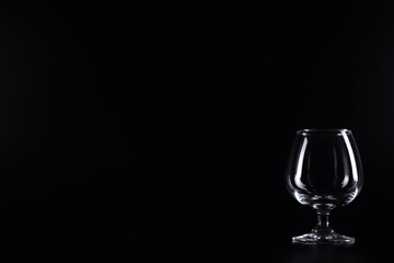 A wineglass on a black background.