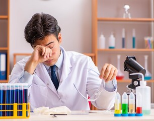Young handsome biochemist working in the lab