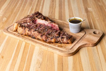 grilled beef steak on wooden background