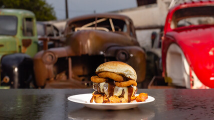 burger on a plate with background junkyard