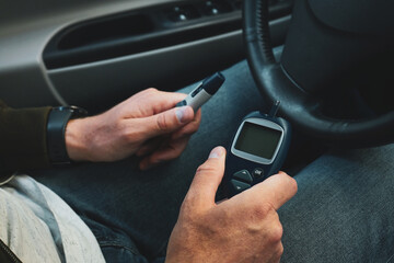 Diabetic man checking blood sugar level, closeup. Diabetes concept.