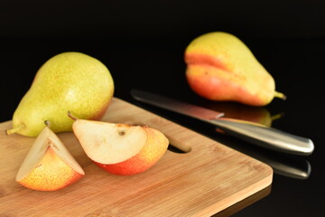 Sweet ripe pears, close-up, on a black background.