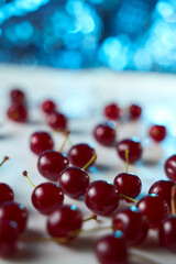 Group of cherry on a white background with shadows. Close-up. Blue Bokeh effect background