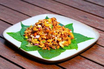 Herb spicy salad with fired shrimp and fish on plate