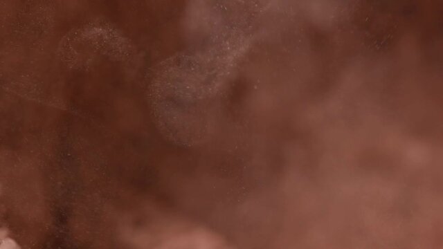 Cocoa powder in a blender. Real gold dust flies in the air. Gold dust is mixed in a blender. Natural cosmetic. close-up
