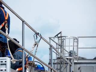 Man Working on the Working at height on construction site with blue sky