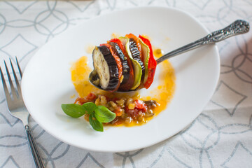 Ratatouille - national french food. Baked vegetables with tomato sauce in a ceramic bowl....