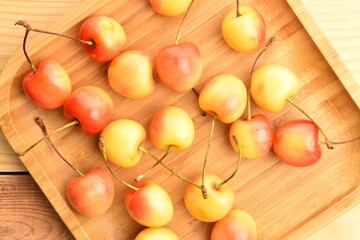 Yellow sweet cherry, close-up, on a wooden table
