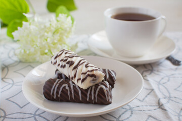 White ceramic cup with tea and chocolate cookies
