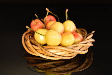 Yellow sweet cherry, close-up, on a black background.