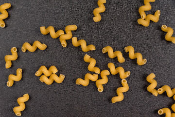 Raw cavatappi on gray background. Cellentani Italian. pasta background