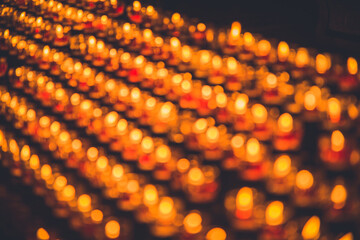 Multiple church candles out of focus