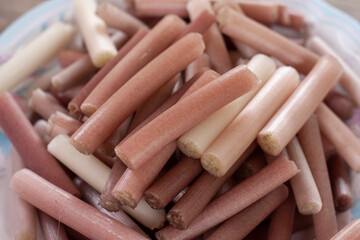 Lotus stem that is cut into parts stacked in a plate to prepare for cooking.