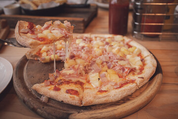 Hawaiian pizza on wooden board