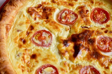 quiche Lorraine with tomatoes food background 